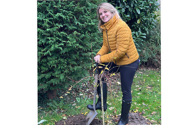 Jess Brown-Fuller planting a tree